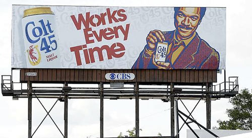 A man in the billboard holding a can of Colt 45, one of the cheapest drinks out there.