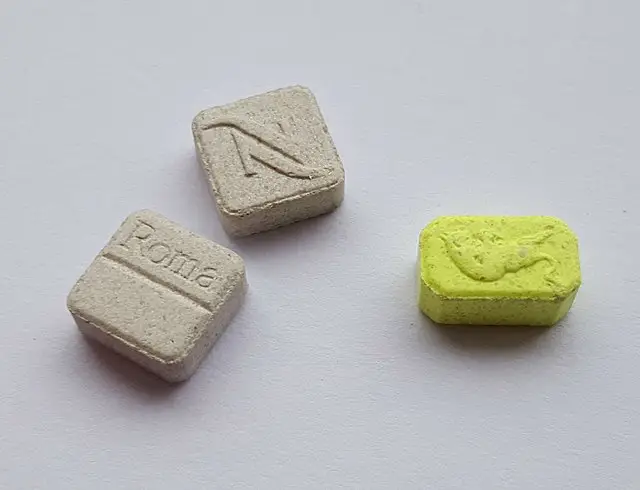 Ecstasy pills in yellow green and dirty white color.