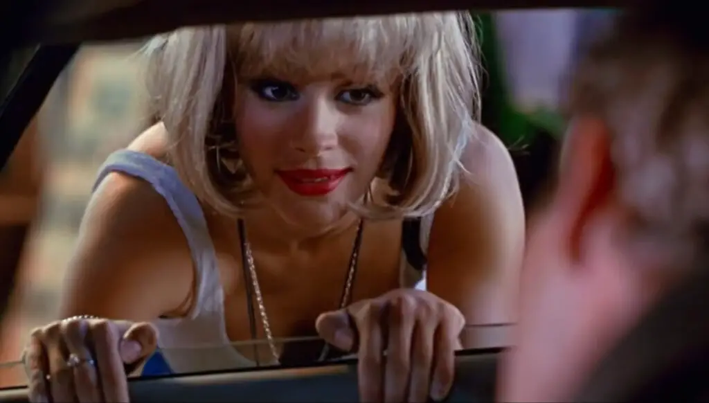 Julia Roberts as the prostitute Vivian approaching through a car window.