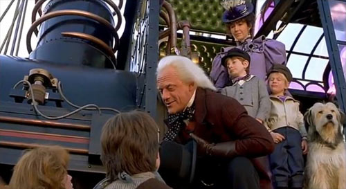 A scene in the movie Back to the Future where a kid at the back points to his private area while Christopher Lloyd makes a speech.