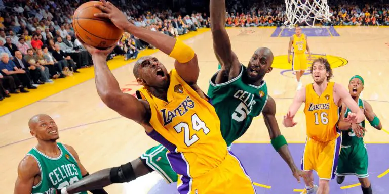 Lakers vs Celtics: Kobe Bryant on the air with the ball against a defender.