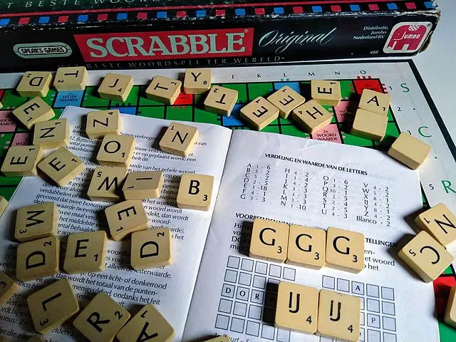 Scrabble tiles over a book in Dutch language.