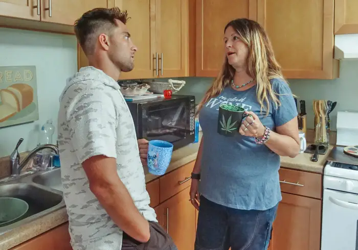 One of the strategies to have sex with your friend or teammate s mom is to give some hints about it in the kitchen, like this young man and an older woman is doing.