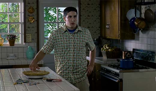 Jason Biggs known as Jim in the kitchen sticking his fingers into a pie.