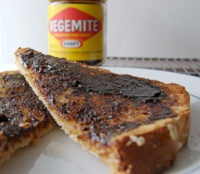 Slice of pie on a plate with Vegemite.