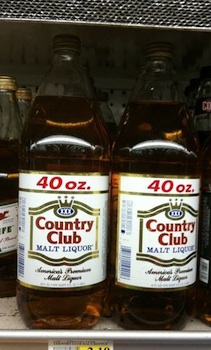 Bottles of Country Club 40 oz displayed on a supermarket shelf.
