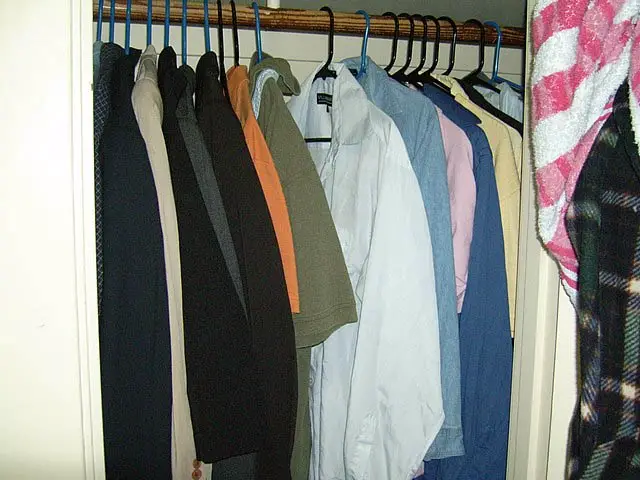 Clothes inside a closet.