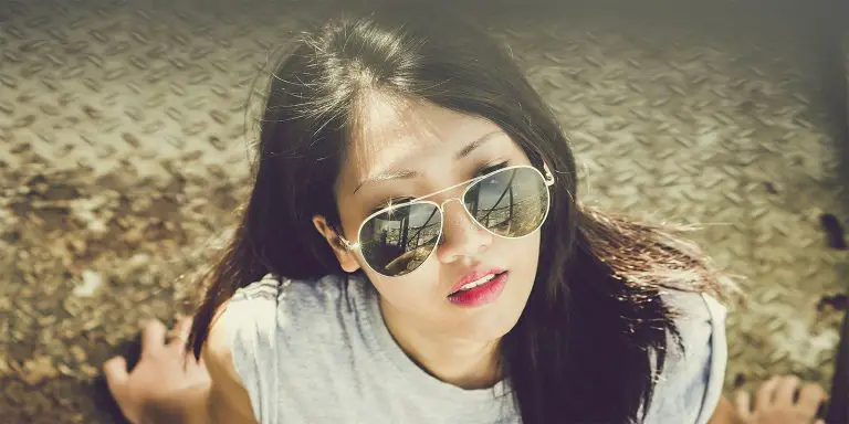 A woman with sunglasses making her look like a cool person.