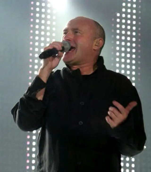 Phil Collins singing with a microphone.