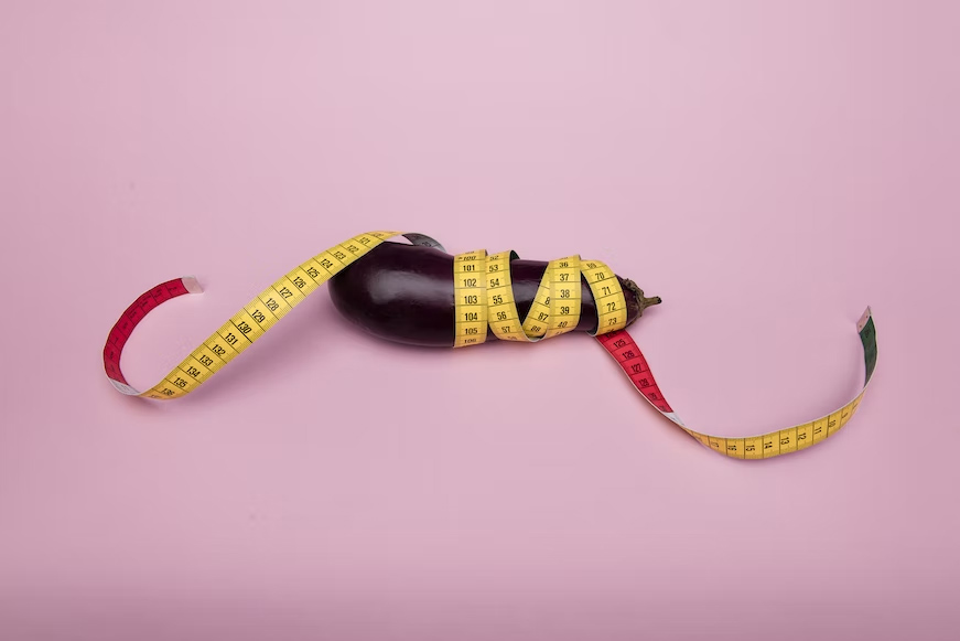 An eggplant with a tape measure rolled around it.