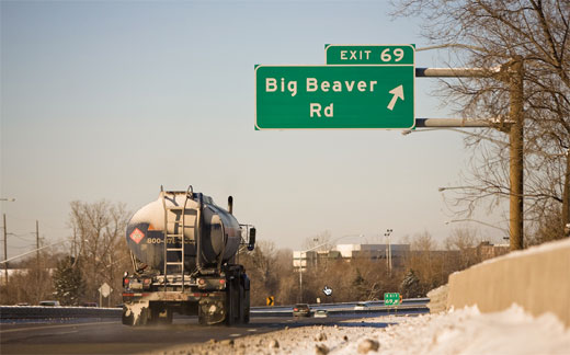 A tanker truck passes by the street sign "Exit 69 off Big Beaver Rd."