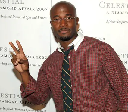 Taye Diggs holding a peace sign with his right hand.
