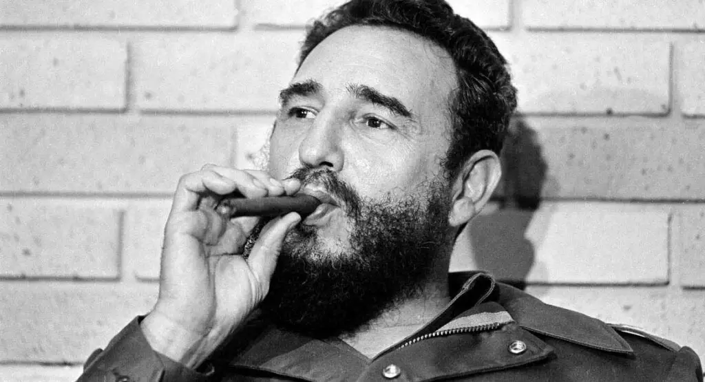 Cuban leader Fidel Castro holding a cigar in his mouth, claimed by his inner circle to have 35,000 sexual partners.