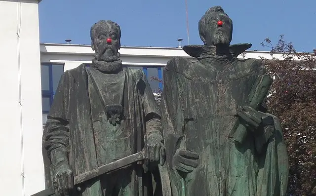 Statue of Tycho Brahe and Johannes Kepler with red nose in Prague.
