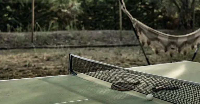 A table with racket and net for ping pong, which is now a proprietary eponym for table tennis.