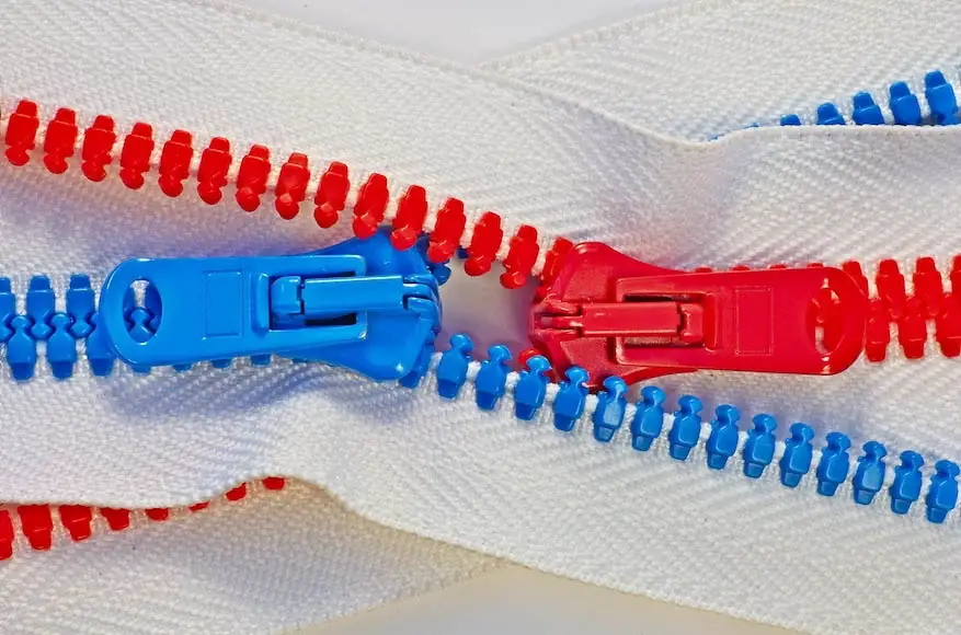 Two hookless slide fasteners or zippers in red and blue color.