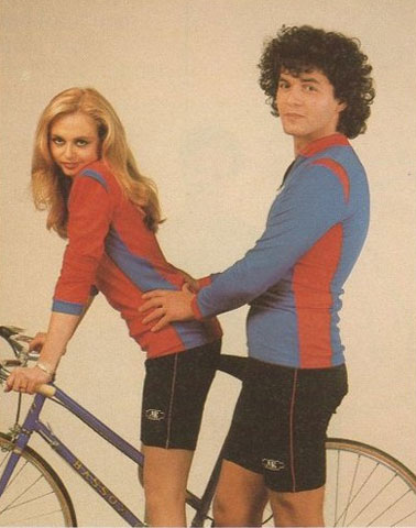 The bike seat looks like the man's penis as he holds the woman's waist while she stands with the bike.