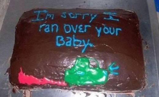 A cake with a message, "I'm sorry I ran over your Baby".