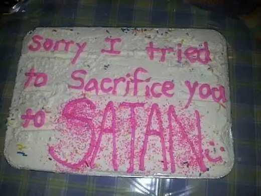 A sorry cake with a weird message that says, "Sorry I tried to Sacrifice you to SATAN :-)"