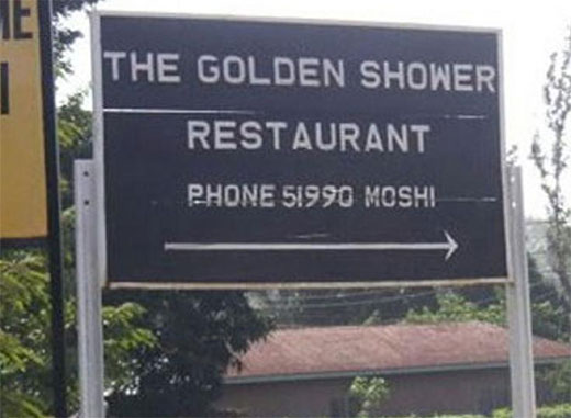 A sign board pointing the direction of a restaurant named, "The Golden Shower Restaurant" which is actually a sexual innuendo.