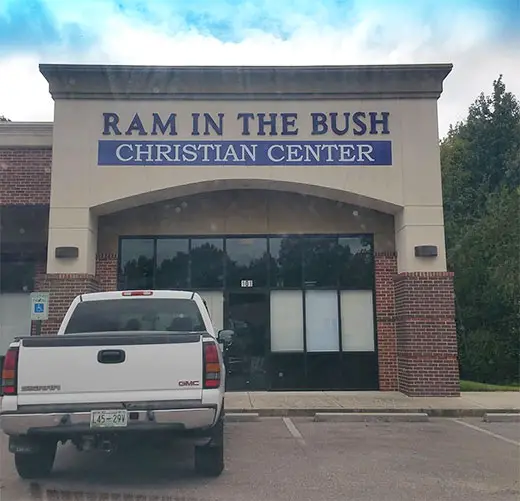 A car parked in front of the church, Ram in the Bush Christian Center that's bursting with sexual innuendo names.
