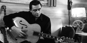 Johnny Cash playing with a guitar.