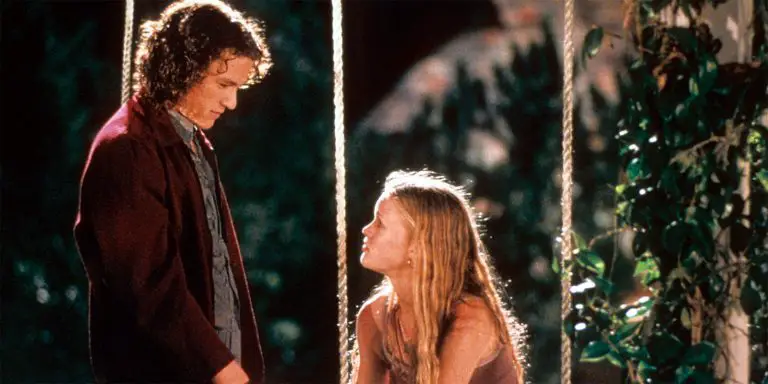Kat sits down on a swing while Patrick talks to him standing in the movie, 10 Things I Hate About You.
