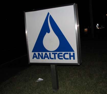 A funny business name sign from Analtech posted in front of the company.