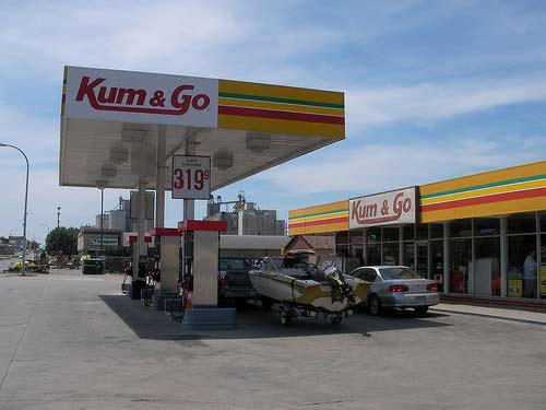 Vehicles lining up at a gas station named Kum & Go