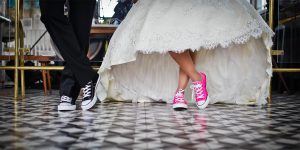 Cousin lovers dressed up while dancing on a checkered floor.