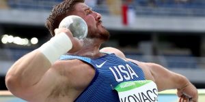 A shot put player ready to throw the metal ball.