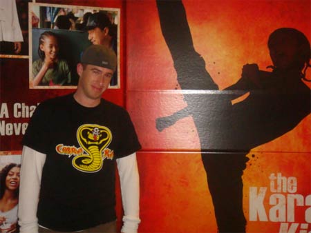 Taking a photo with Jaden's film poster for the Karte Kid remake where his silhouette is performing a kick.