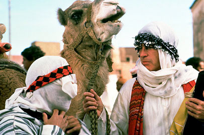 Two Middle Eastern characters in the movie, Ishtar leading a camel.